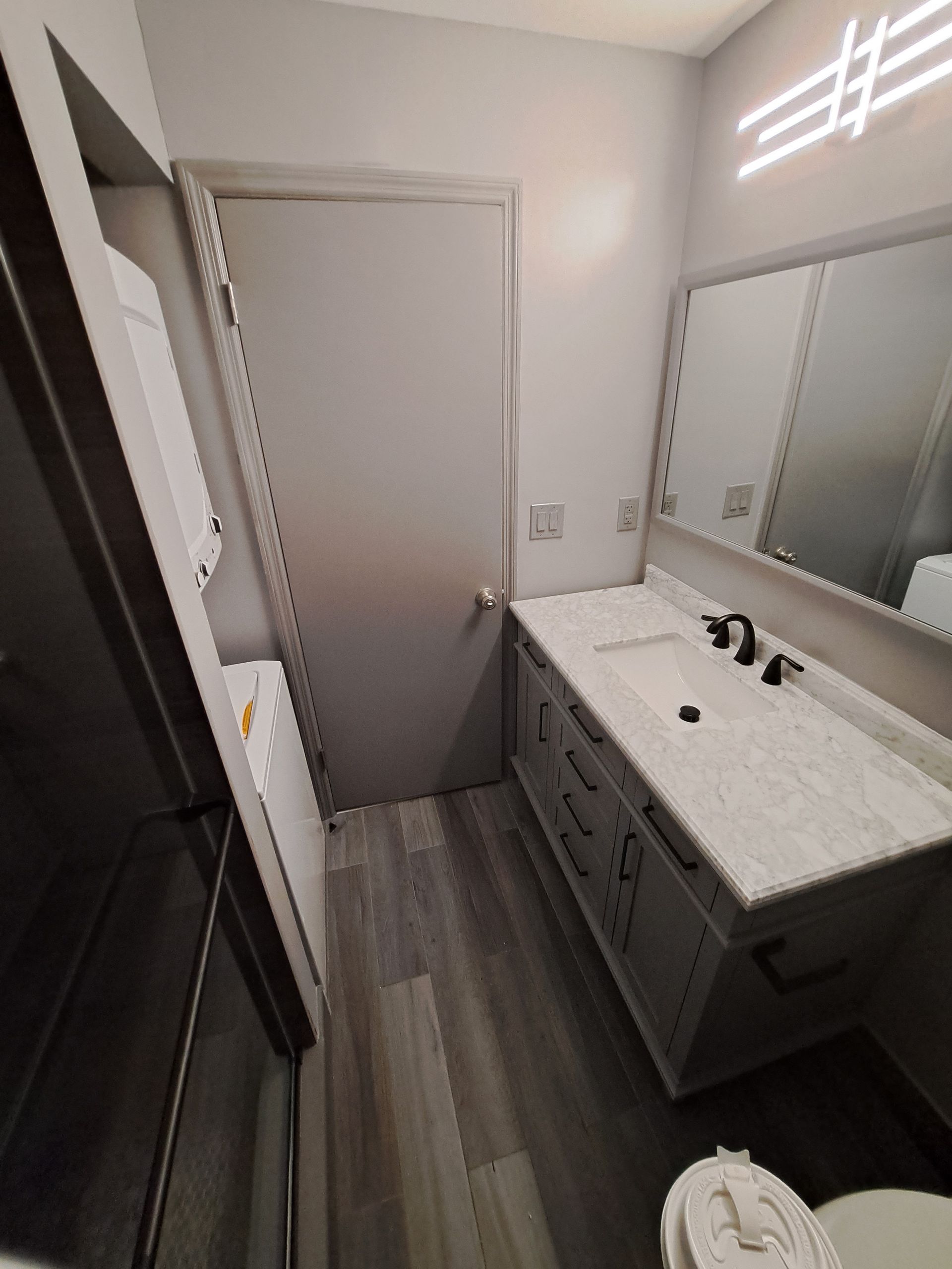 A bathroom with a sink , toilet and mirror