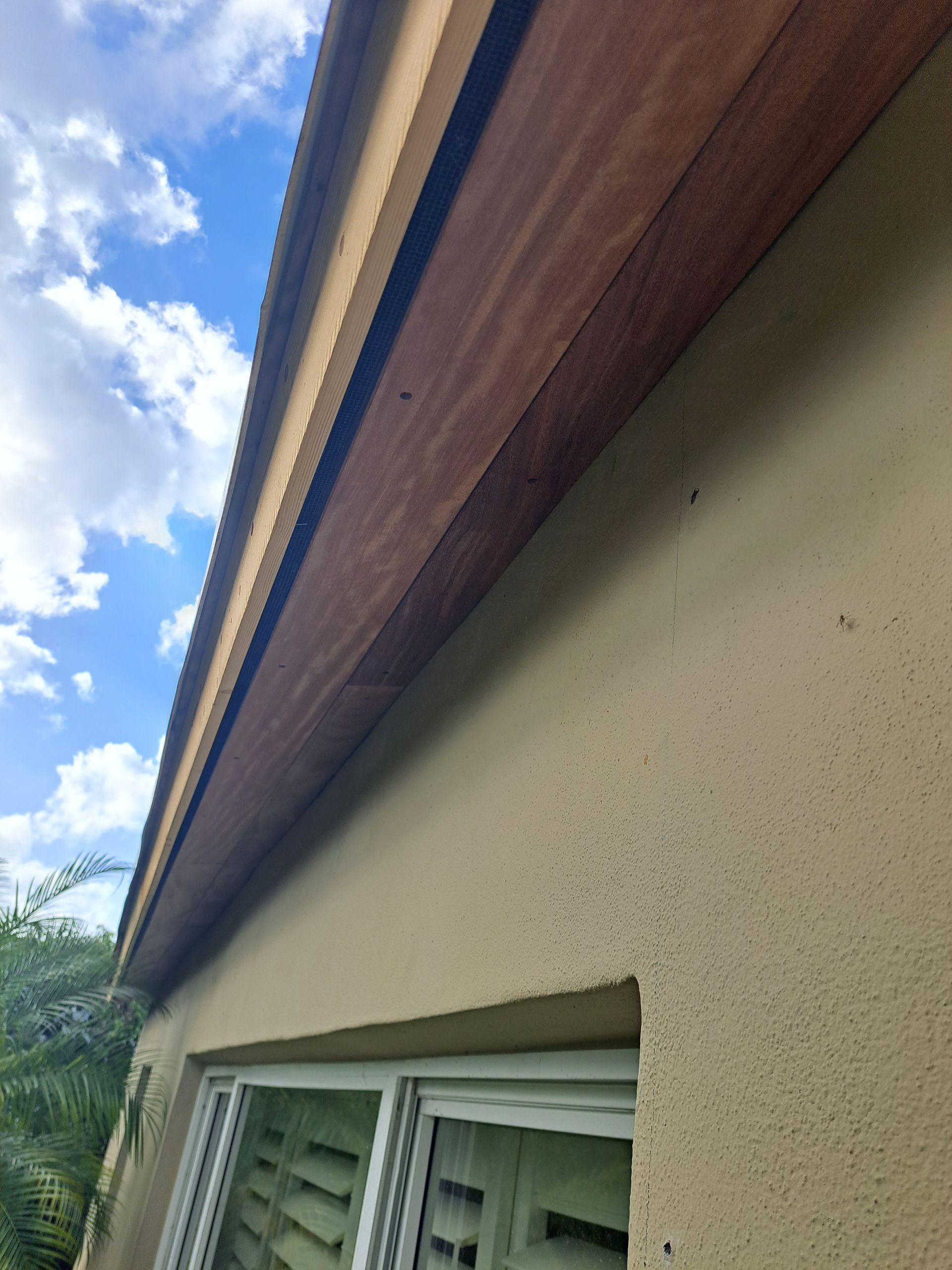 Looking up at the roof of a house with a window