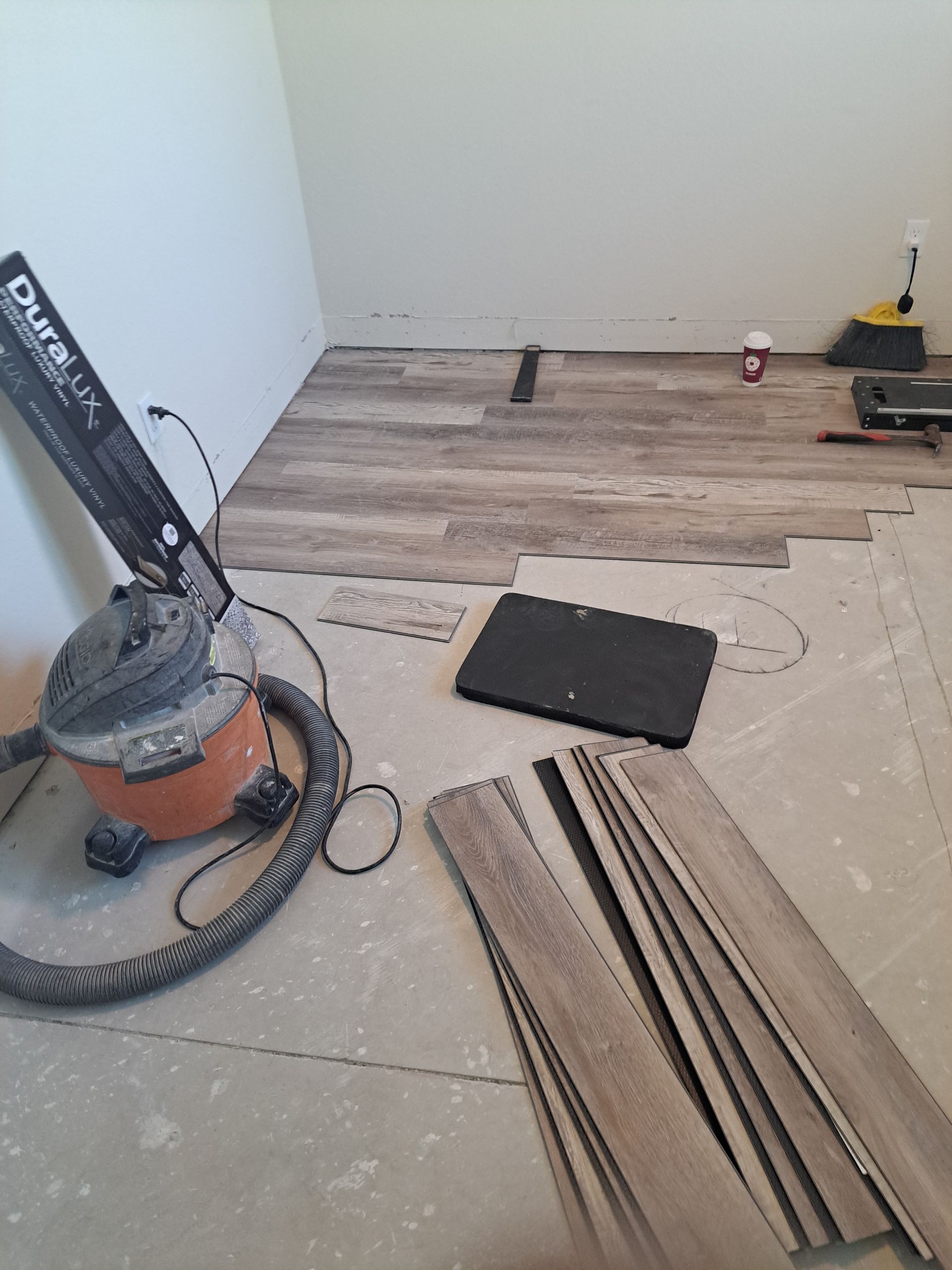 A vacuum cleaner is sitting on the floor in a room.