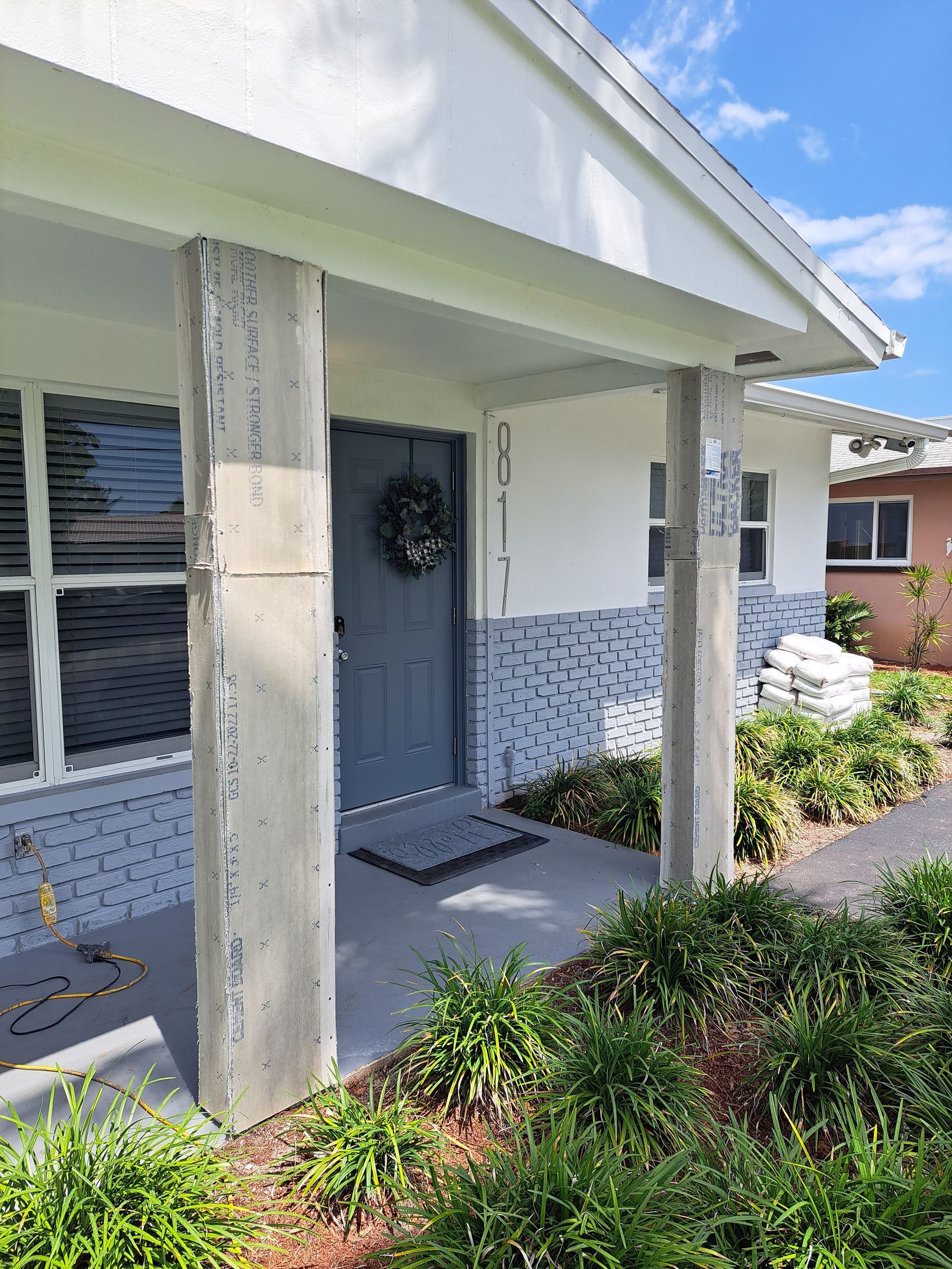 The front door of a house with a wreath on it.