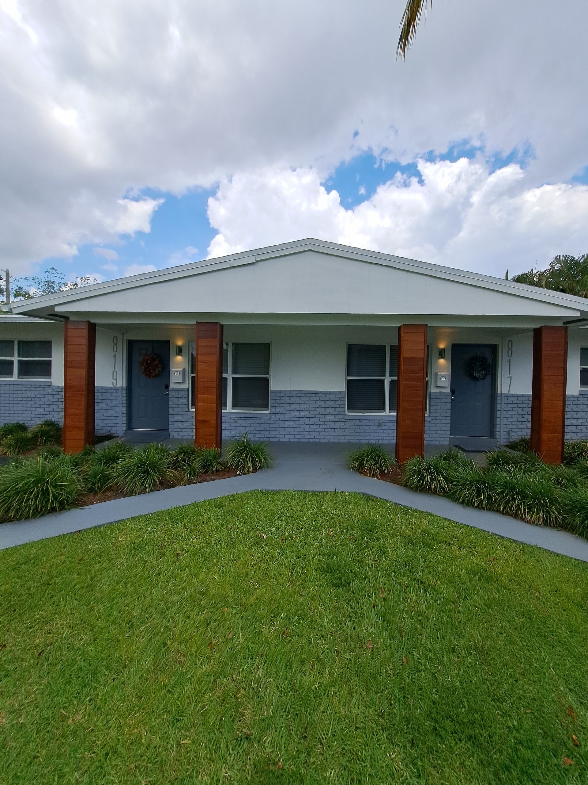 A house with a large lawn in front of it