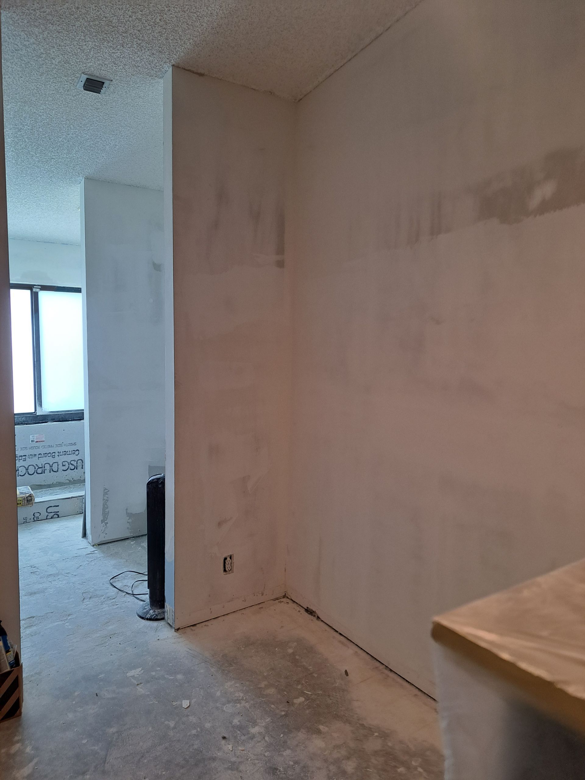 A room with white walls and a sink in it.