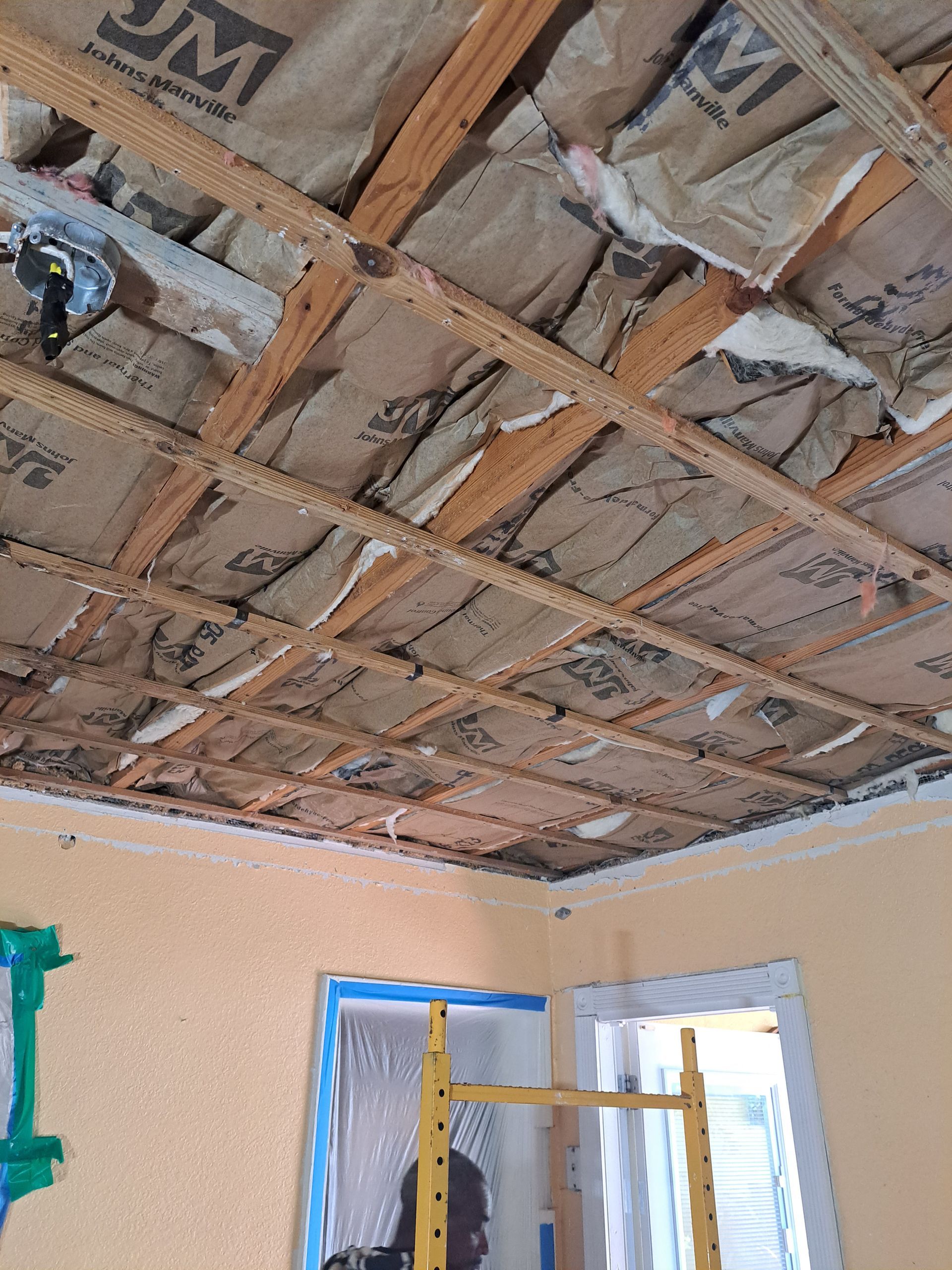 A room with a ceiling that is being remodeled.