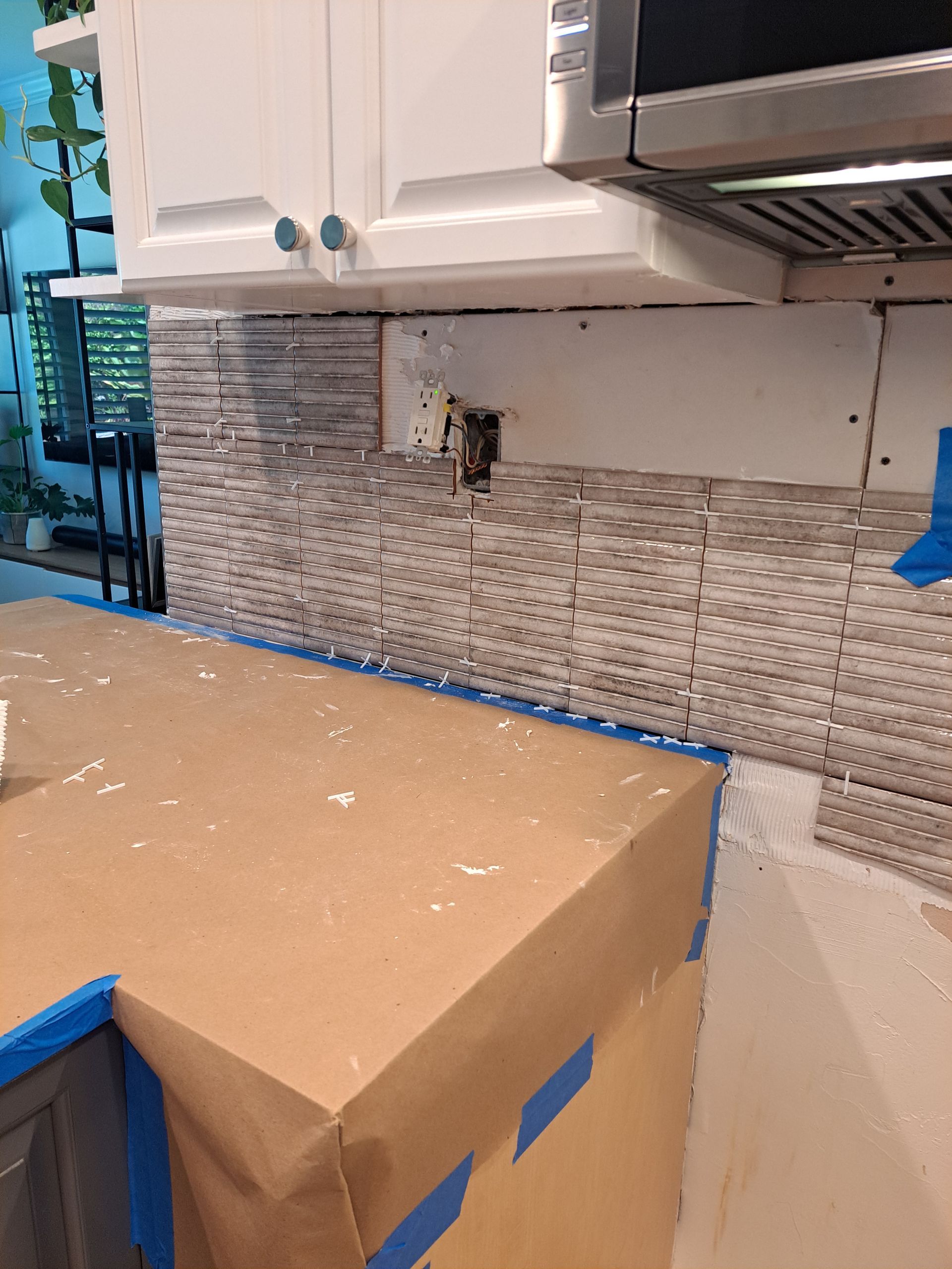 A kitchen counter with a box on top of it.