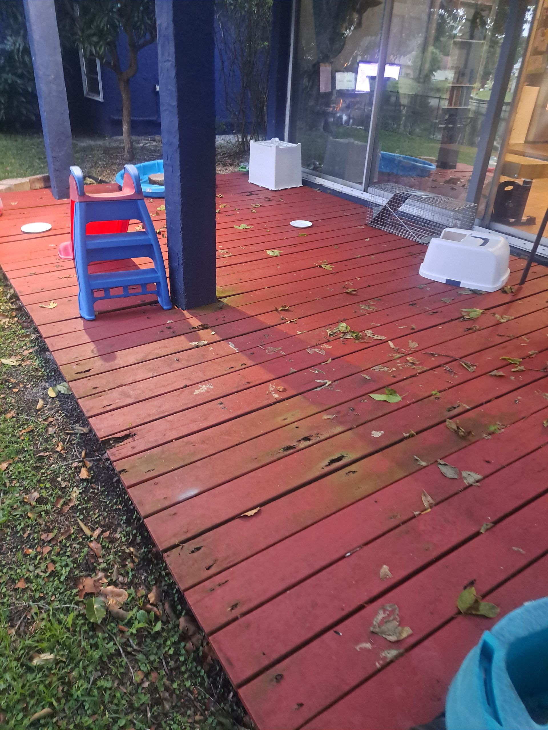 A red deck with a blue chair on it