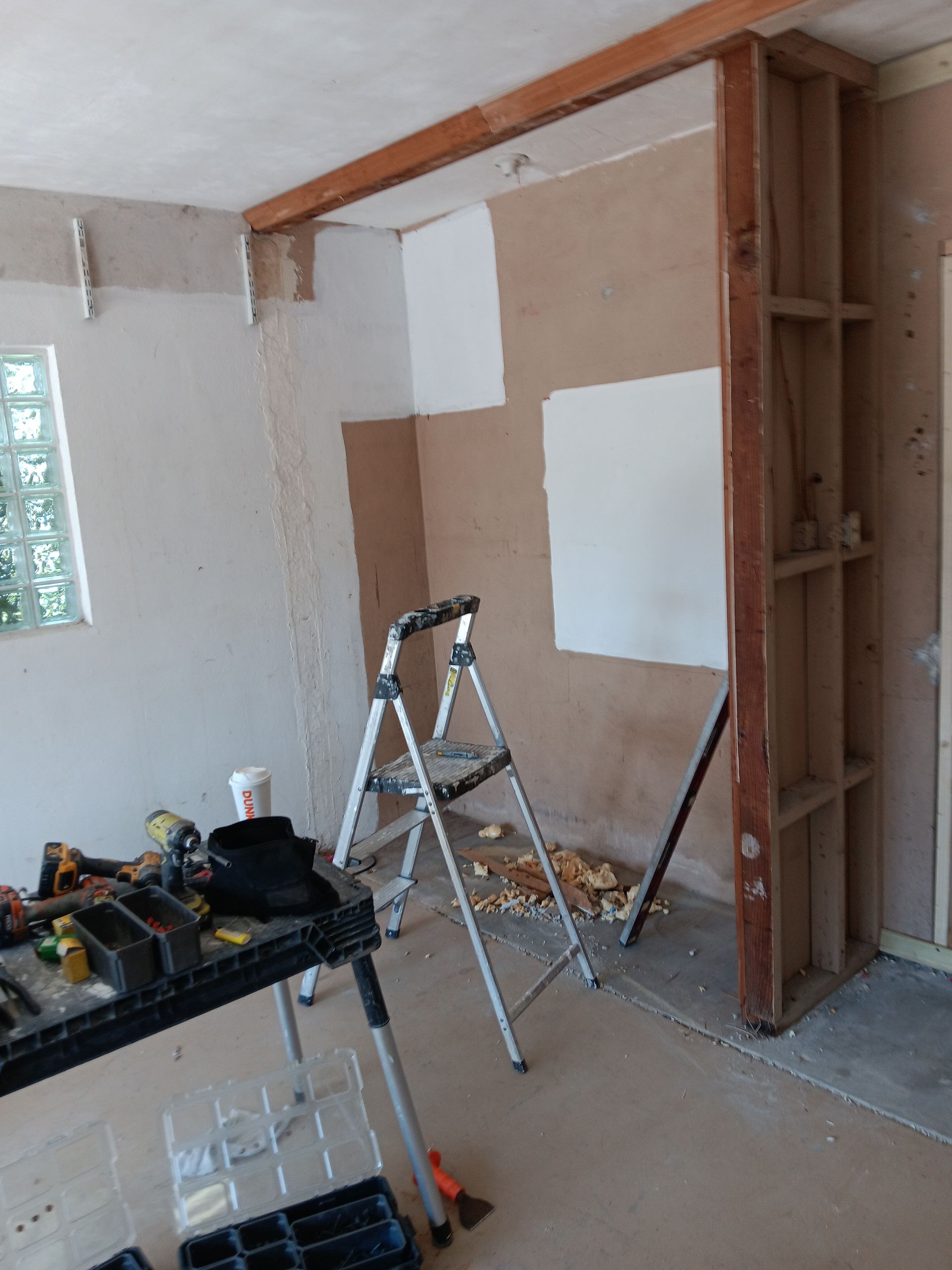 A room under construction with a ladder and a table