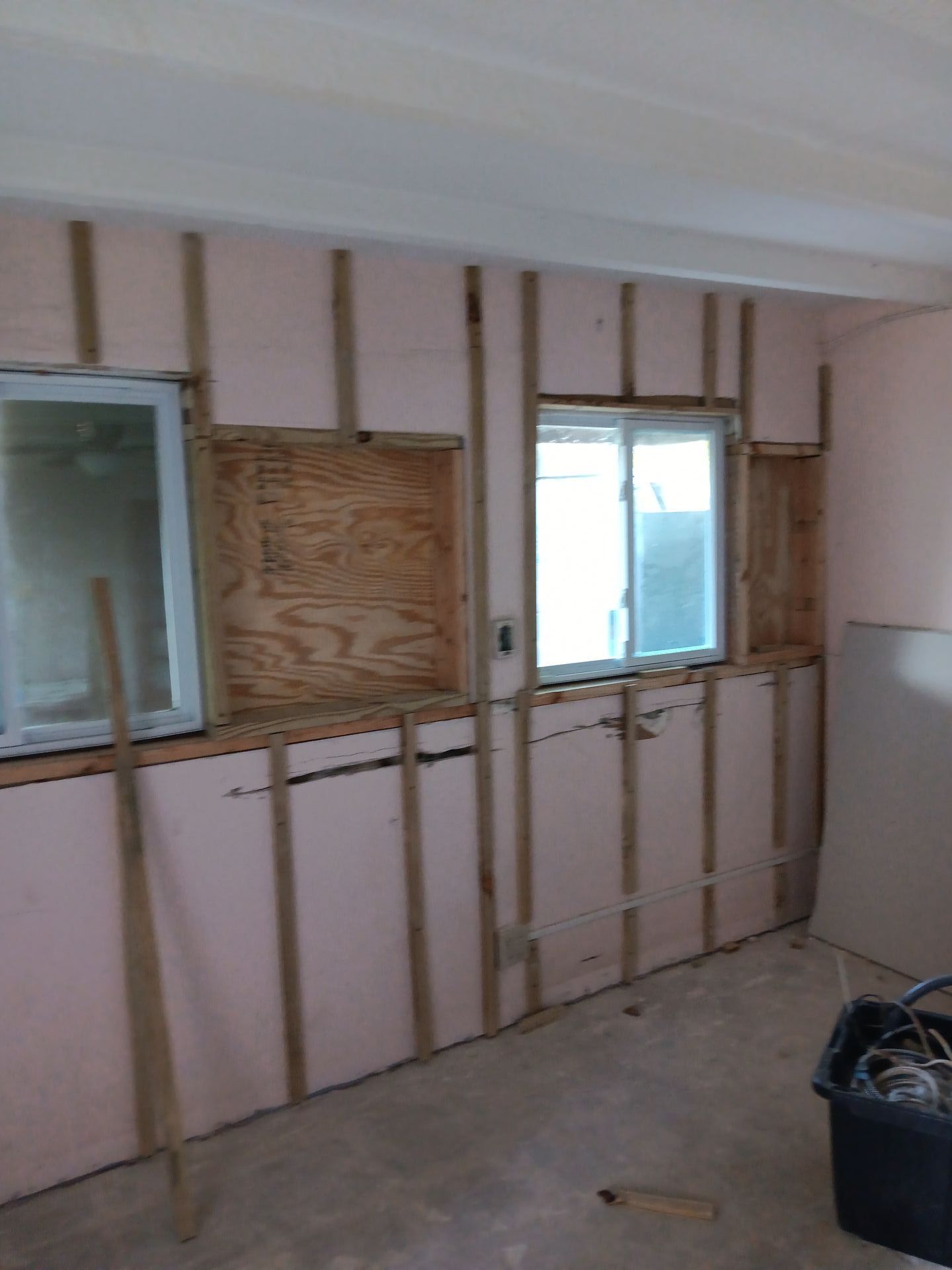 A room with a window and a wooden frame.