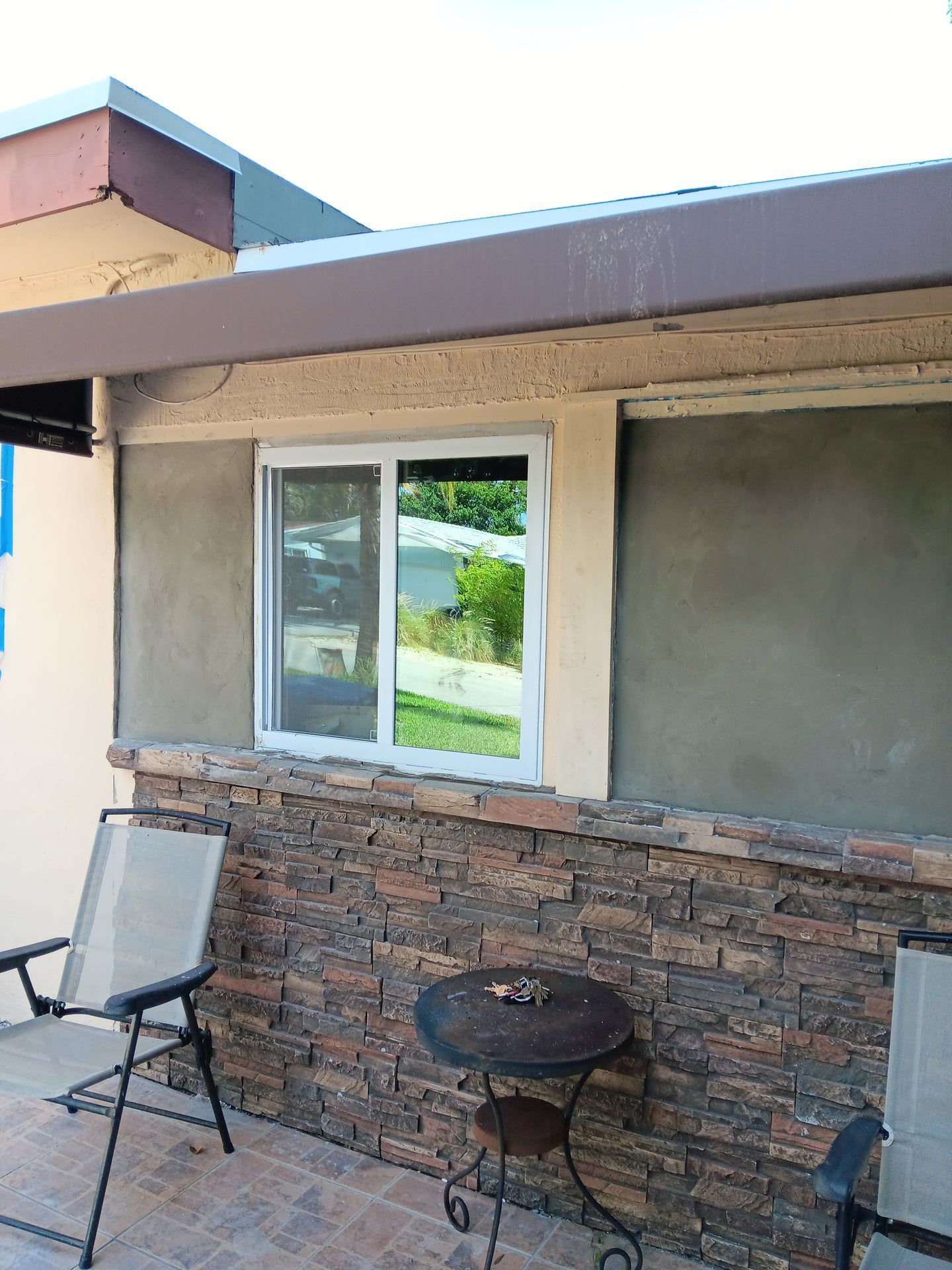 A house with a window and a stone wall
