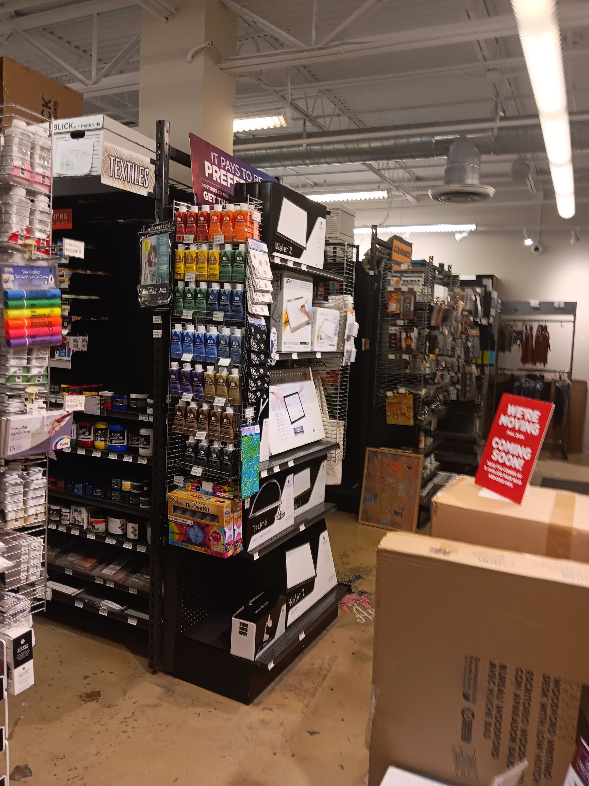 A store aisle with a sign that says ' new arrivals ' on it