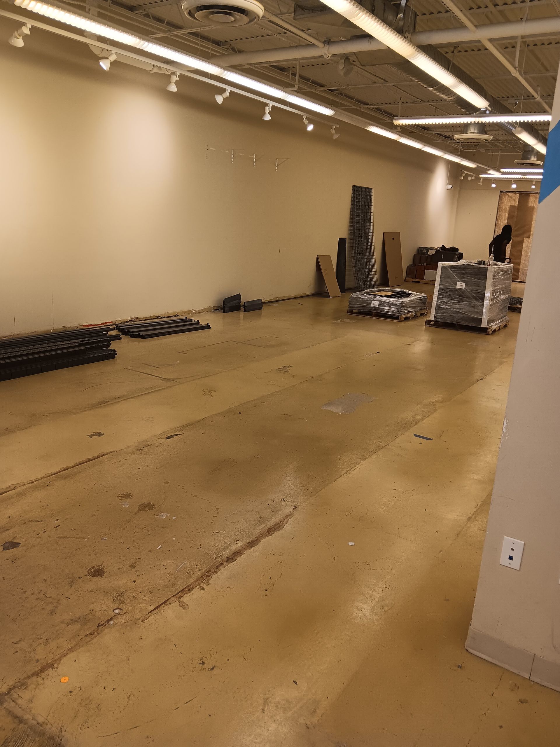 A large empty room with a lot of boxes on the floor