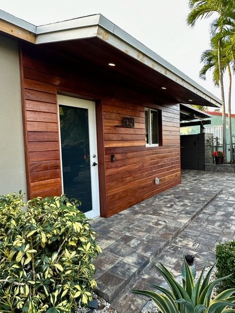 A house with a wooden siding and a white door