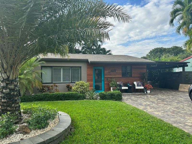 A house with a palm tree in front of it