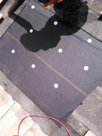 A shadow of a person is cast on a black surface