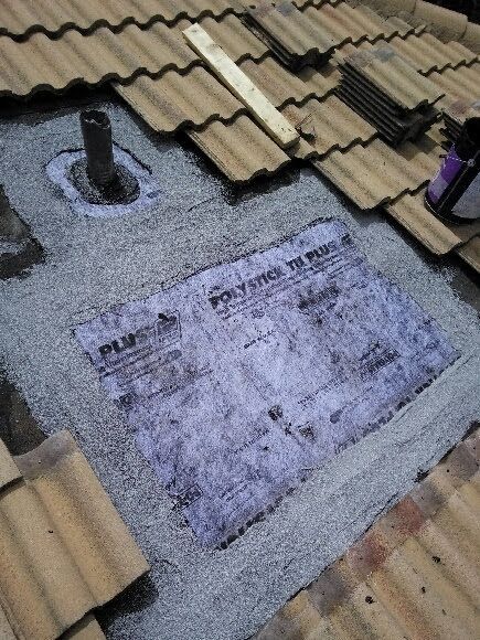 A roof with a hole in it and a piece of paper on it.