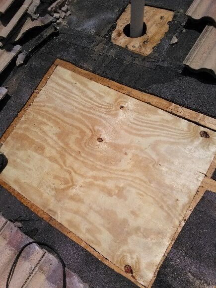 A piece of plywood is sitting on top of a wooden floor.