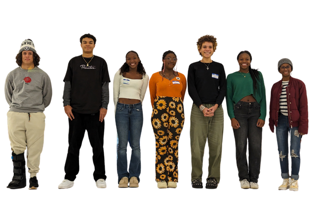 A group of young people standing next to each other and smiling.