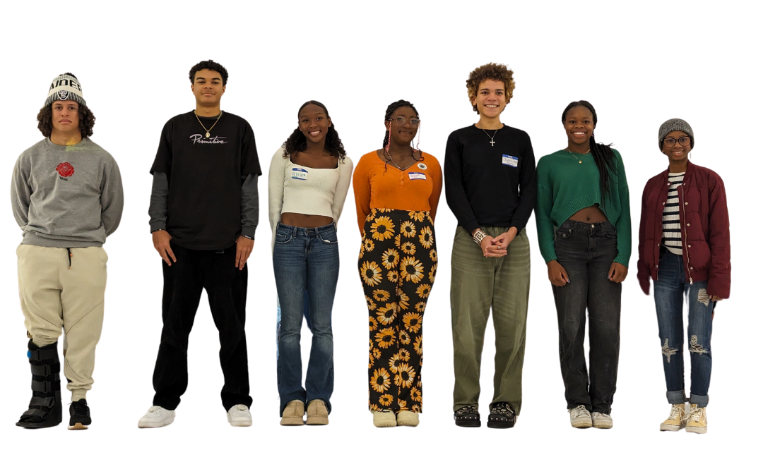 A group of students standing next to each other smiling for a picture.