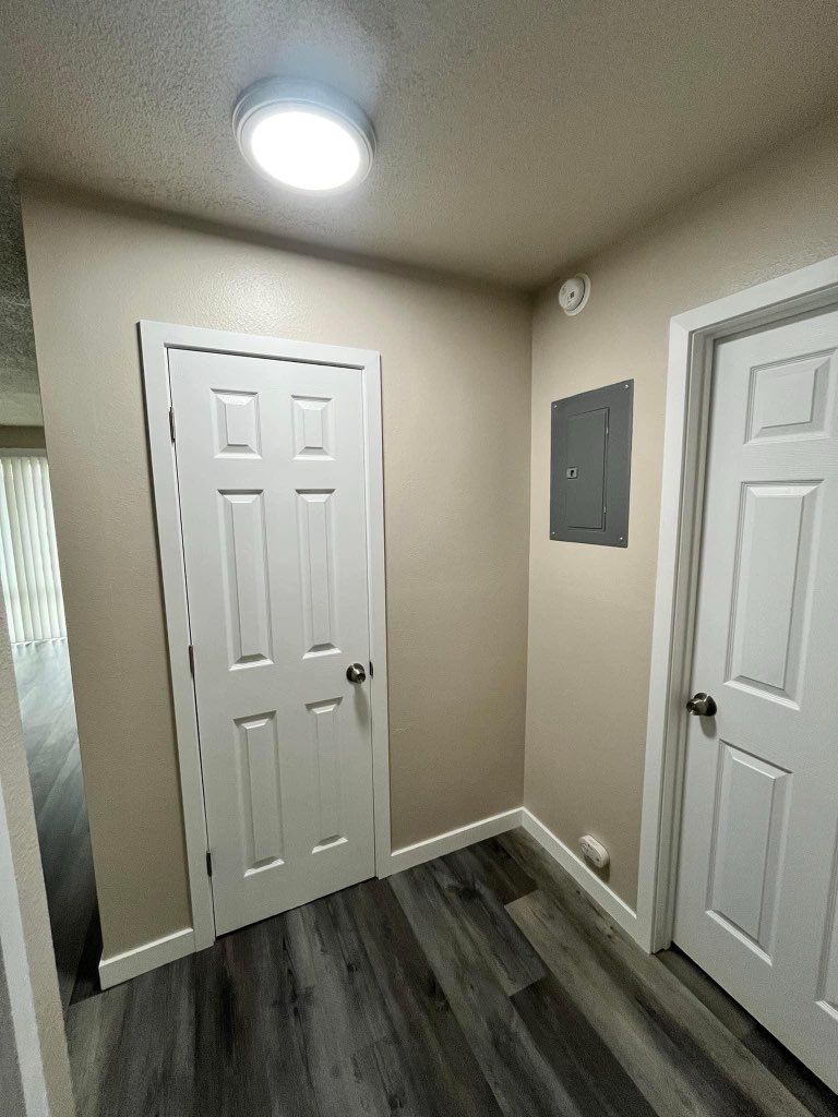 A sliding glass door is sitting on the side of a house next to a ramp.