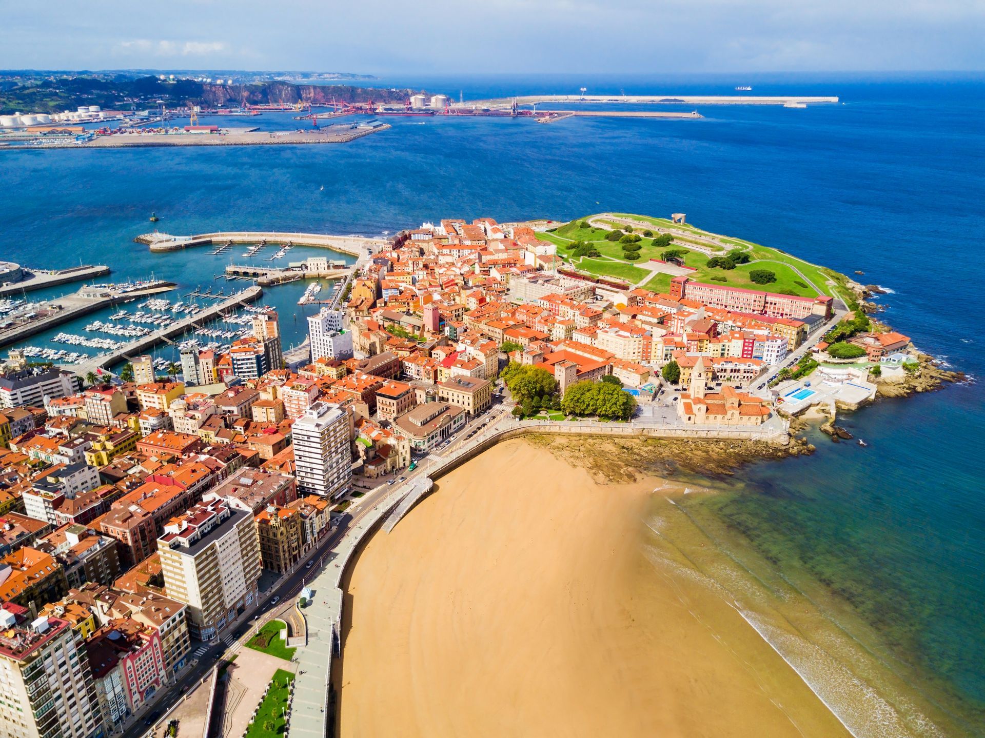 An aerial view of a city on a small island in the middle of the ocean.