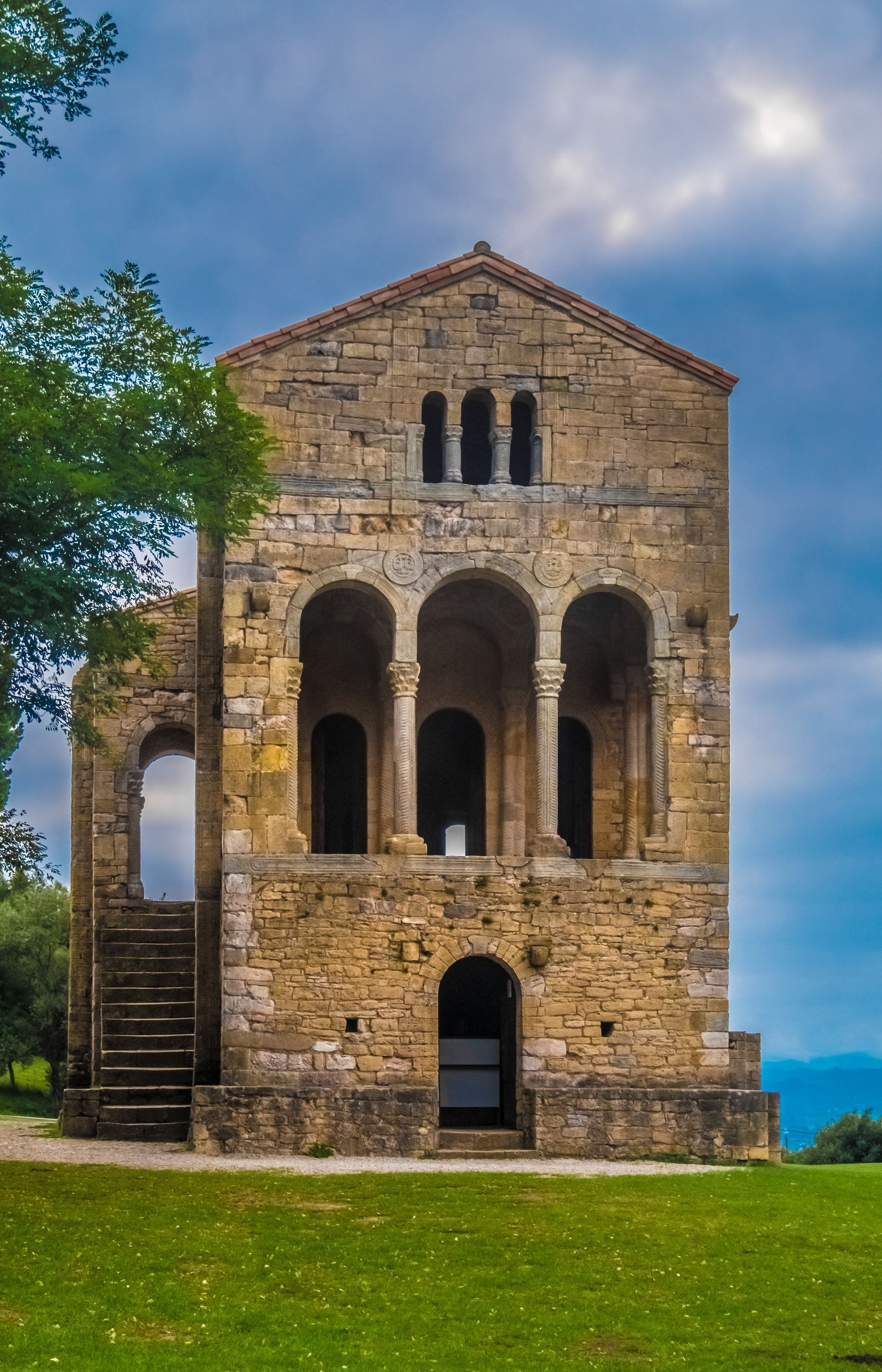 A large stone building with arches and stairs