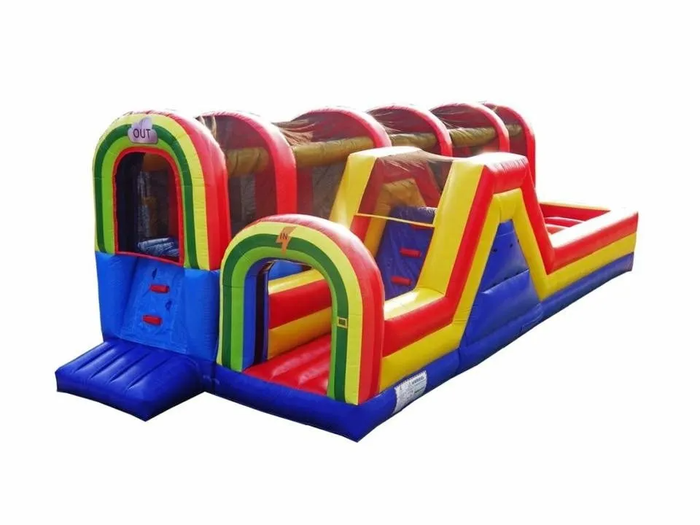 happy excited boy having fun on inflatable attraction playground