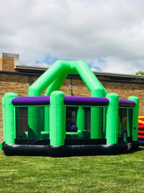 happy excited boy having fun on inflatable attraction playground