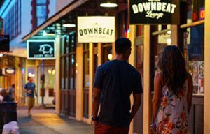 A man and a woman are walking down a city street.