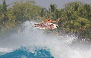 A man is riding a wave on a surfboard.