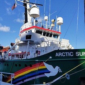 A green boat with a rainbow and a dove on the side is called the arctic sun.