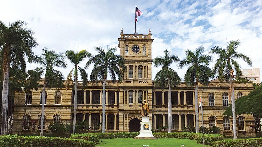 A large building with palm trees in front of it