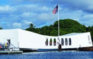 A large white building is sitting on top of a body of water.
