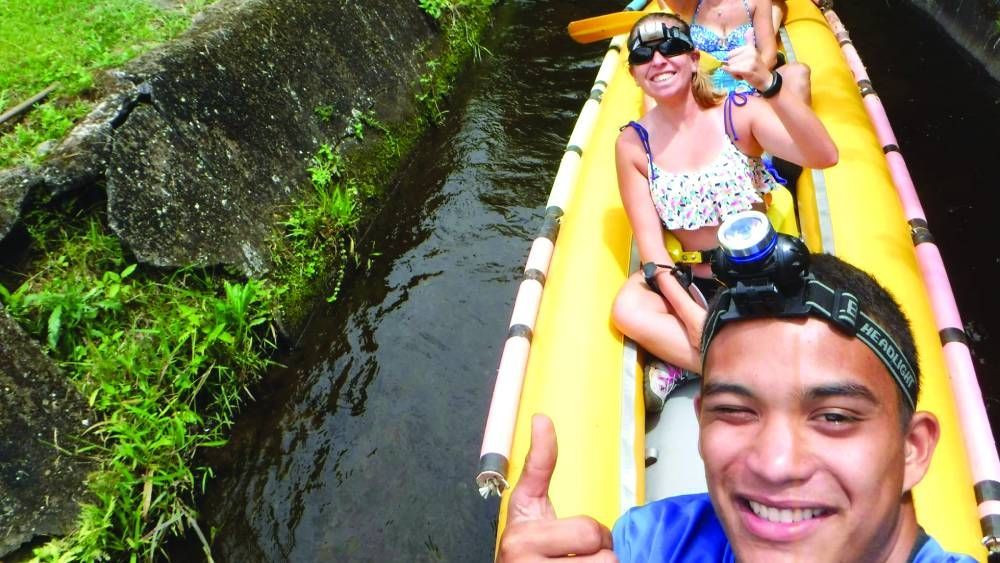 A man in a yellow kayak is giving a thumbs up