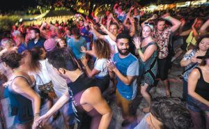 A large group of people are dancing at a party.