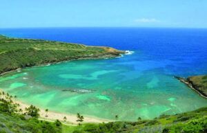 A large body of water with a beach in the middle of it.