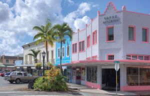 A row of colorful buildings are lined up on a city street.