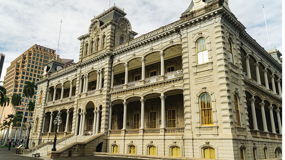 A large building with a lot of windows and balconies in a city.