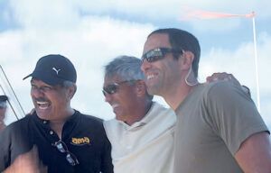 Three men are posing for a picture on a boat.