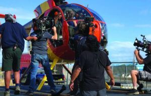 A group of people are standing around a helicopter.