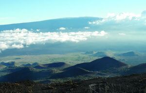A view of a mountain range with clouds in the sky.