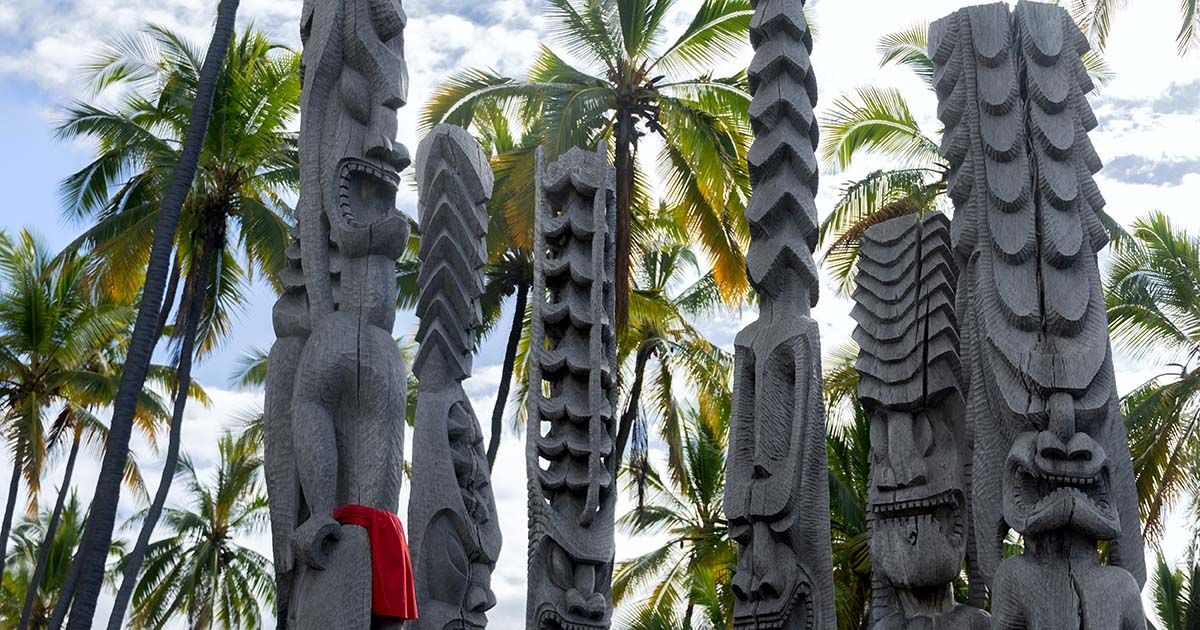 Wooden ki‘i statues standing guard at Puʻuhonua o Hōnaunau National Historical Park on the Big Island.