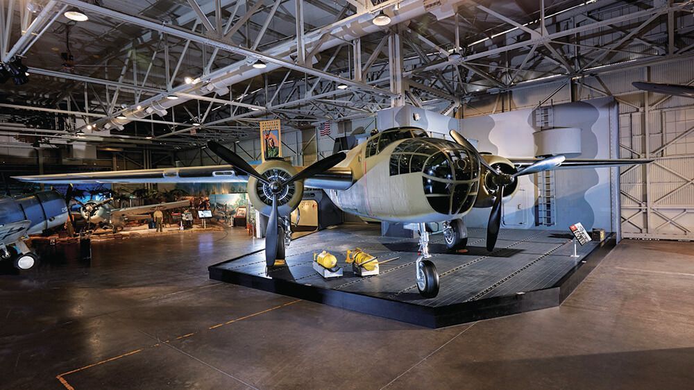 An old airplane is on display in a hangar.