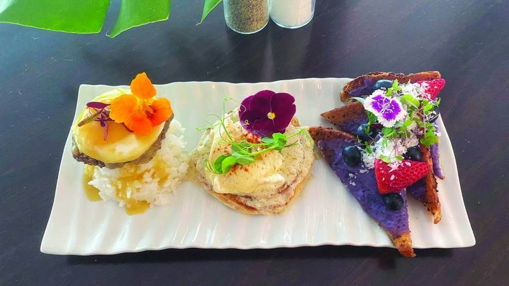 Three different types of food are on a white plate on a table.