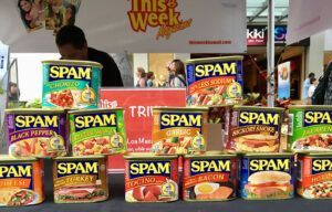 A bunch of cans of spam are sitting on a table.