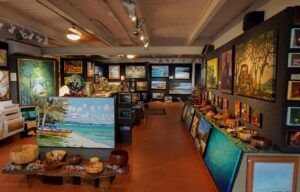 A large room filled with lots of paintings on the walls.