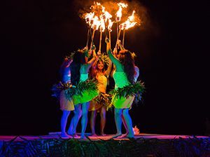 A group of women are holding flaming torches in their hands.