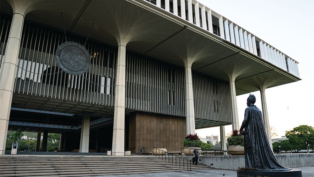 A large building with a statue in front of it.