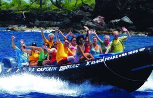 A group of people are riding a boat in the ocean.