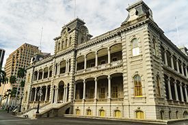 A large building with a lot of windows and balconies in a city.