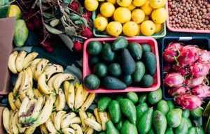 There are many different types of fruits and vegetables on the table.