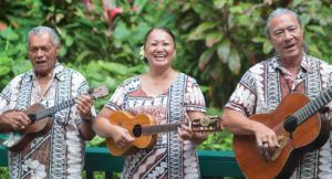 A group of people are playing guitars and ukuleles.